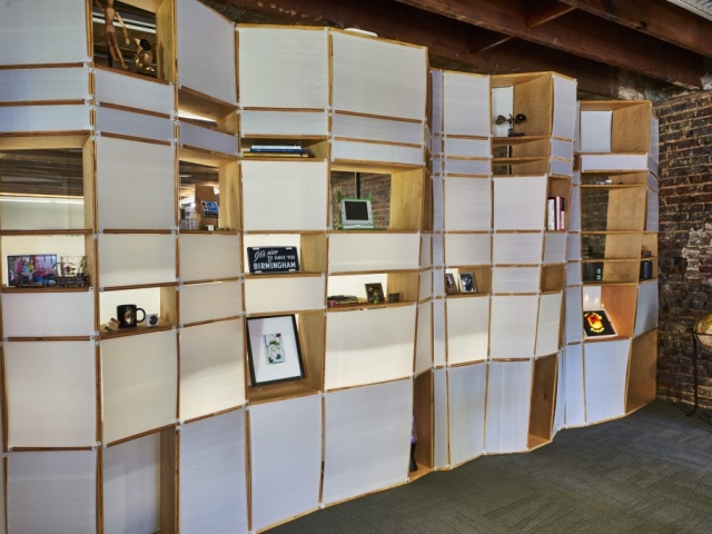 Kinetic's signature wave walls made of wood and plastic. Features several places for photos and other memorabilia.
