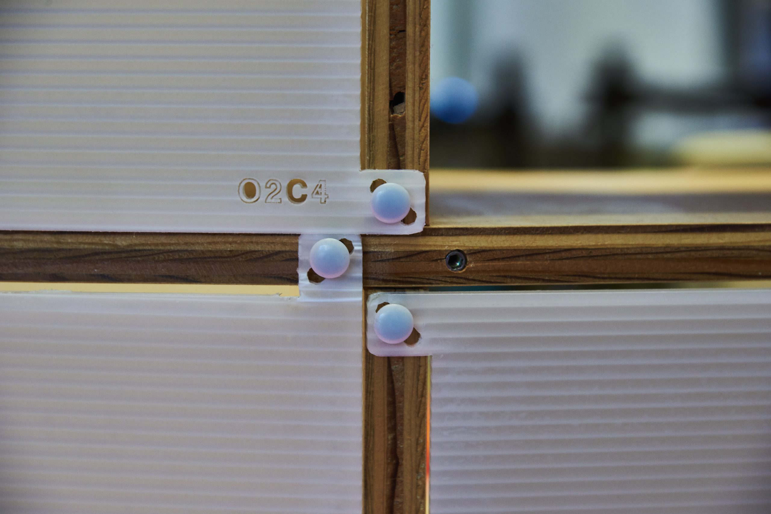 Color up of the plastic panel connectors on the signature Kinetic shelves.