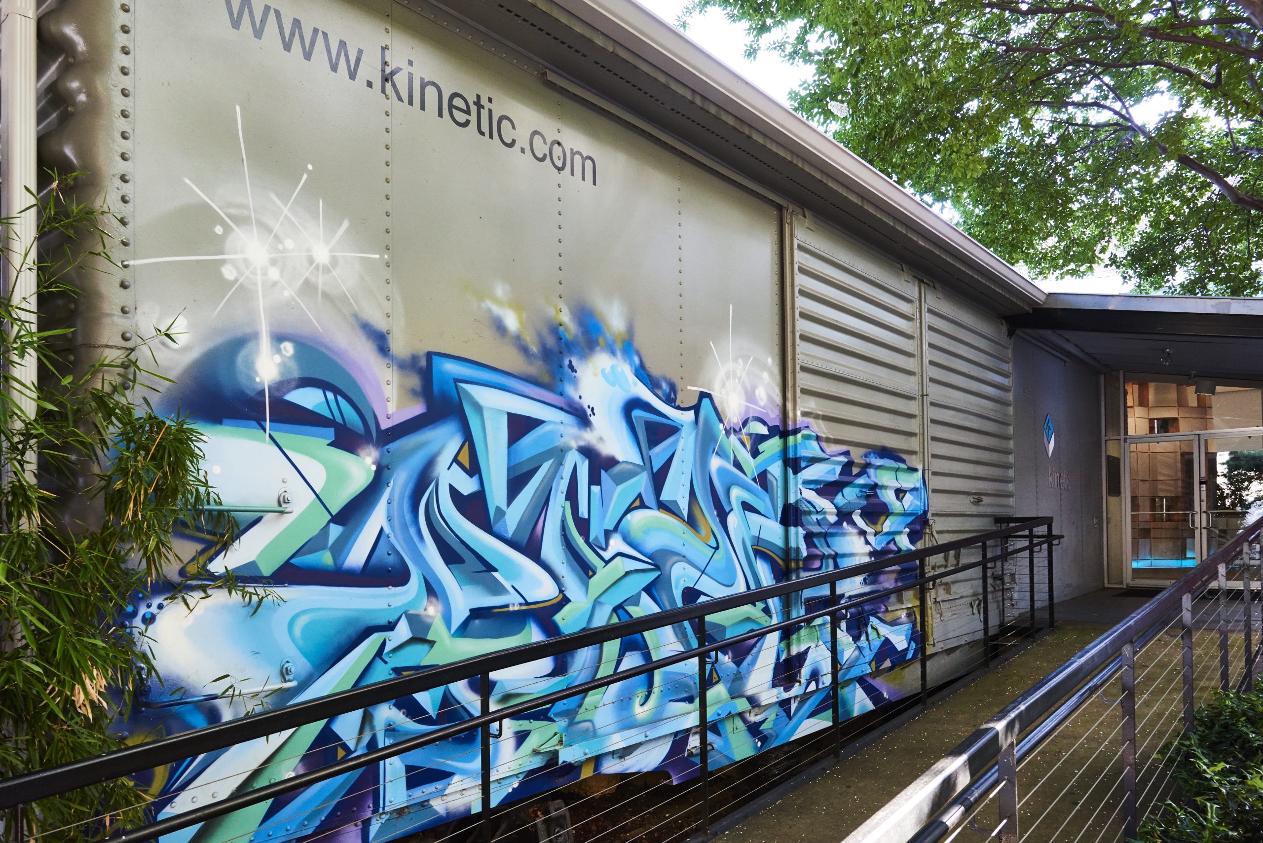 Photo of the boxcar placed along the front entrance ramp complete with artwork and web address.