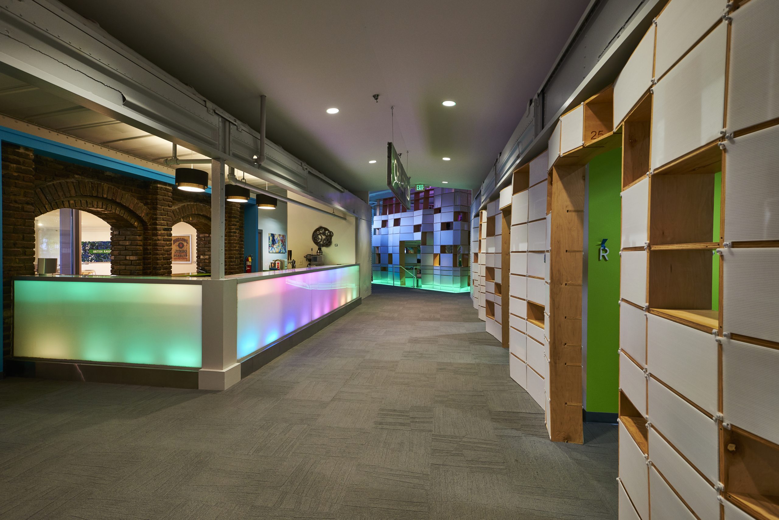 Photo of the area between the two box-cars inside Kinetic. Offices are on the right whereas a LED bar is on the left.